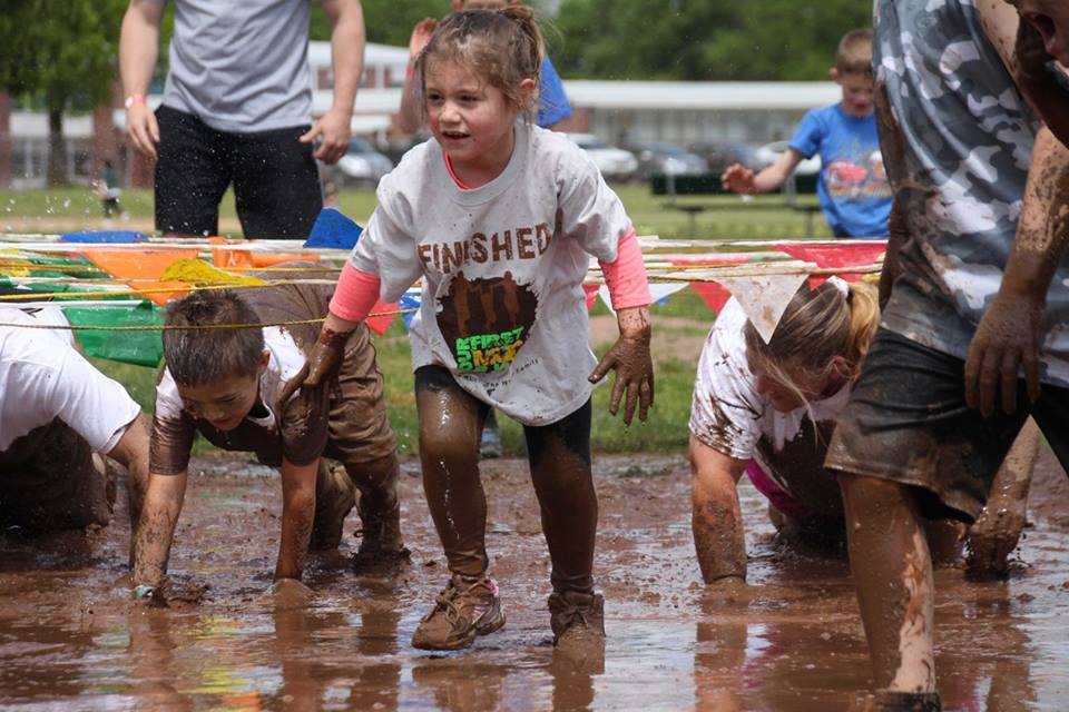 A little girl enjoying the mud run