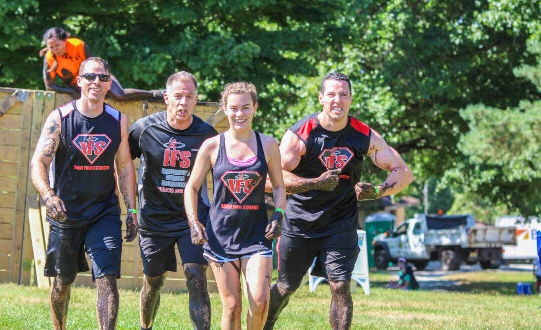 Three men and a girl in black attire are running