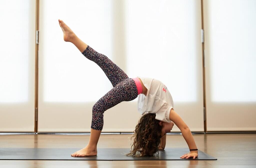 a little girl doing a Yoga Pose