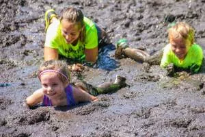 two kids and a woman during the mud run