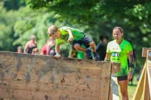 a little boy jumping a board during the run