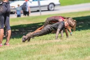 two little girls doing the push ups on the ground