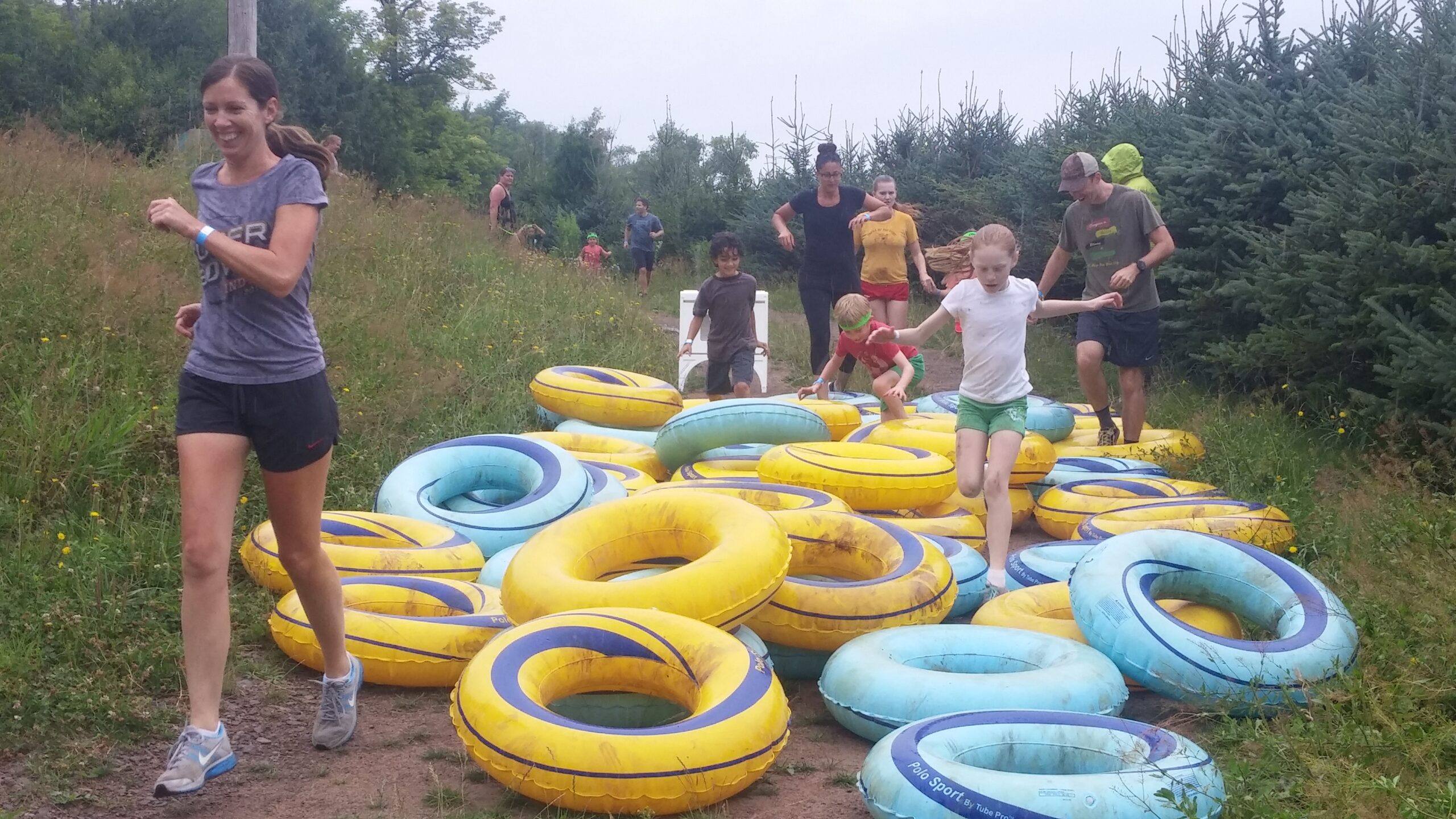 two kids and a woman during the mud run