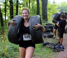 two kids and a woman during the mud run