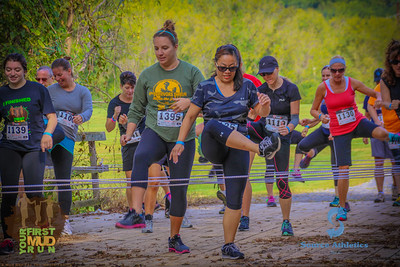 two kids and a woman during the mud run