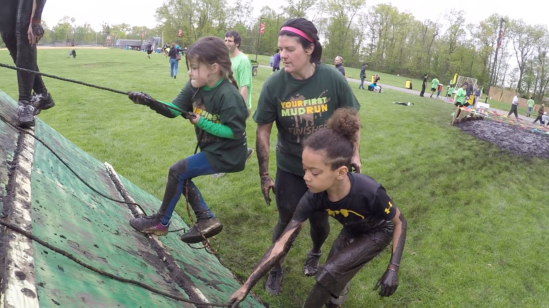 two kids and a woman during the mud run