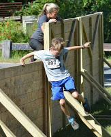 two kids and a woman during the mud run